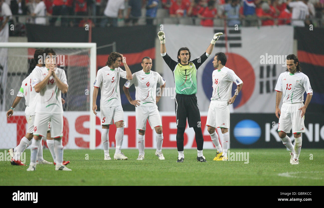 Iran's Andranik Teymourian (left), Hadi Aghili, Seyed Jalal Hosseini, goalkeeper Seyed Mehdi Rahmati (3rd right), Mohammad Nosrati and Mohammad Nori stand dejected after the final whistle Stock Photo
