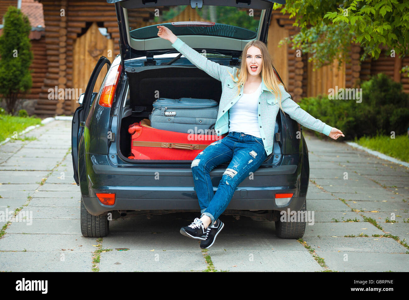 woman posing next to car Stock Photo - Alamy