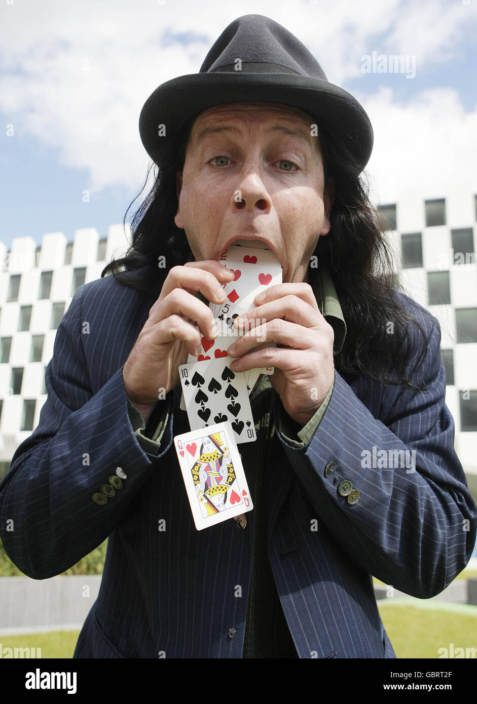 Magician Nick Nicolas vomits up a deck of cards as part of his act at the launch of the AIB street performance championships at Grand canal dock in Dublin today. Stock Photo