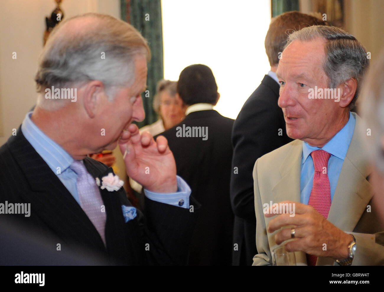 The Prince of Wales talks with journalist Michael Buerk, during a reception at Clarence House to thank supporters of the African Medical and Research Foundation. Stock Photo