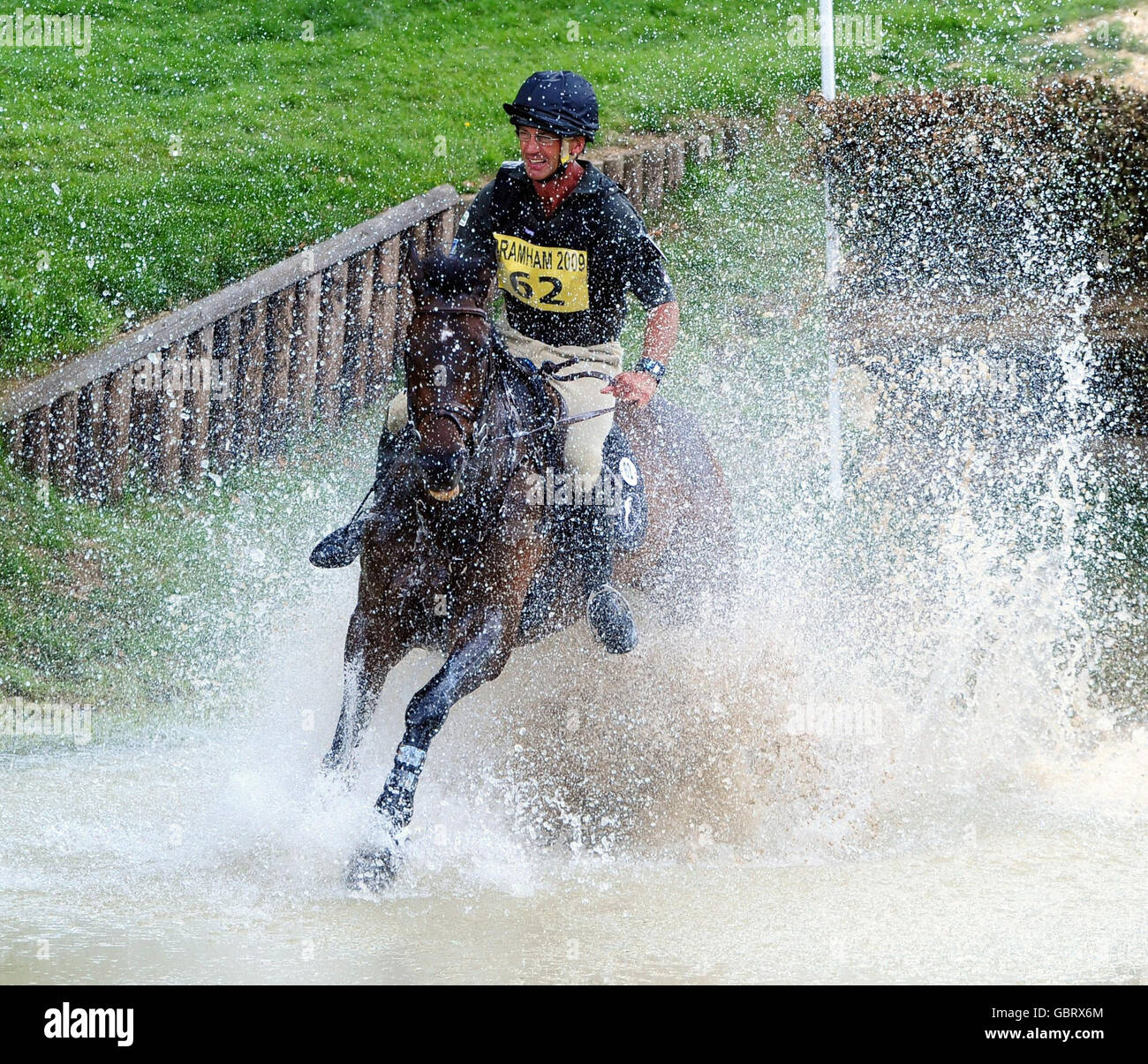New Zealand's Andrew Nicholson riding The Light Fandango at the water jump on the Cross Country Course during the Bramham International Horse Trials at Bramham Park, Yorkshire. Stock Photo