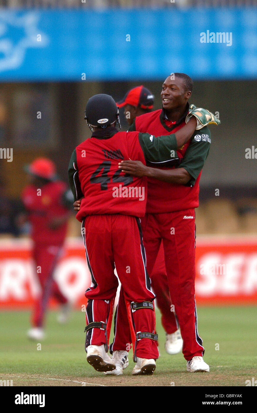 Zimbabwe's Vusimuzi Sibanda (r) is congratulated upon taking the wicket of England's Vikram Solanki Stock Photo