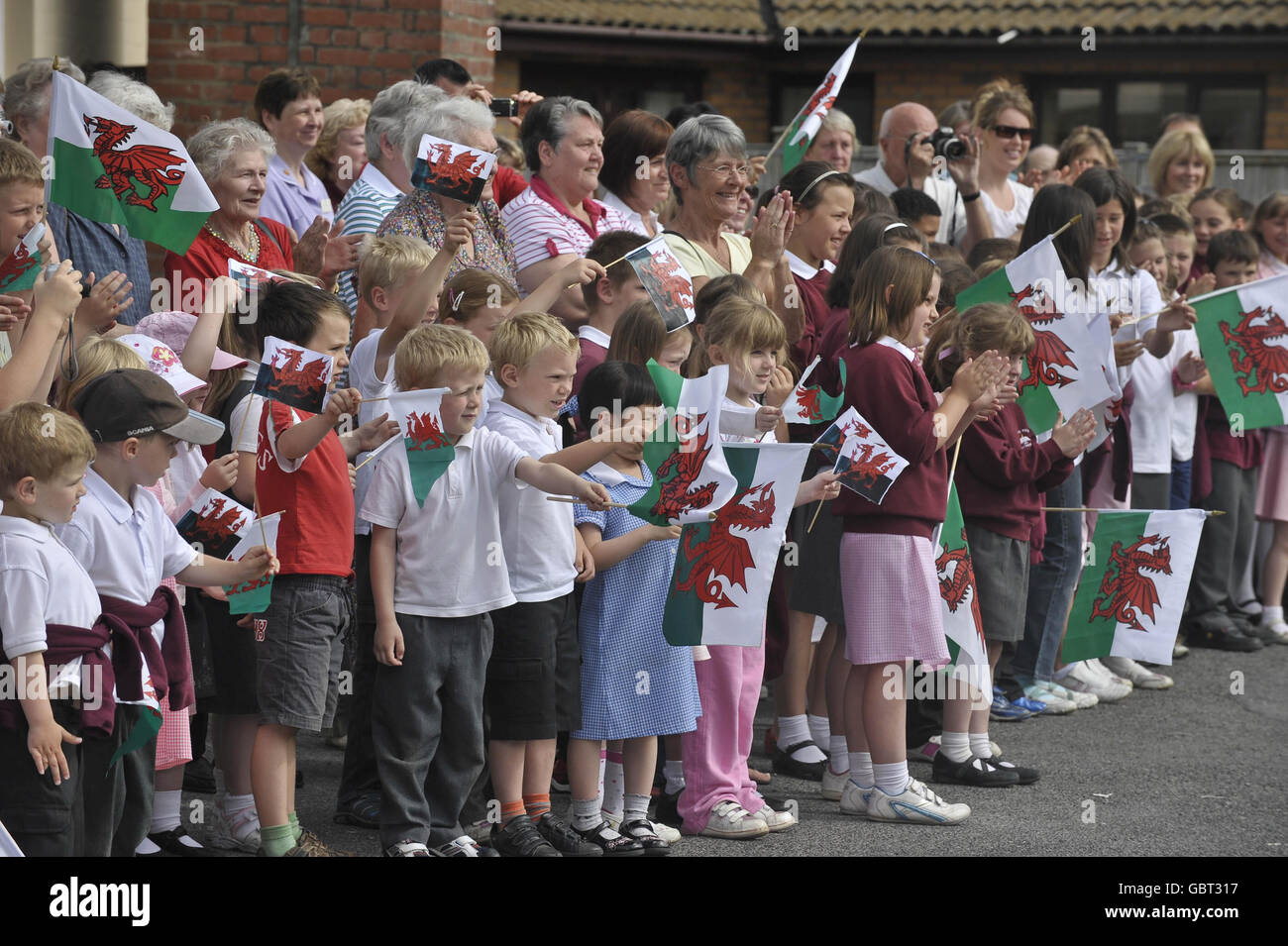 children-from-ysgol-rhys-pritchard-primary-school-wave-flags-as-they