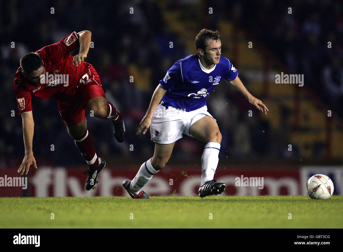 Bristol City's Bradley Orr (l) is sent flying by a challenge from Everton's James McFadden (r) Stock Photo