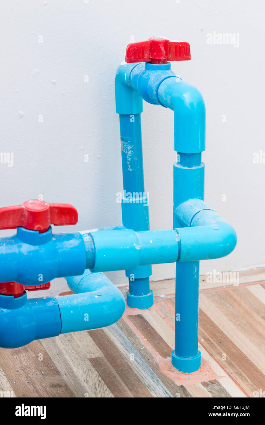 Red plastic valve on the PVC pipe for control the water tank Stock