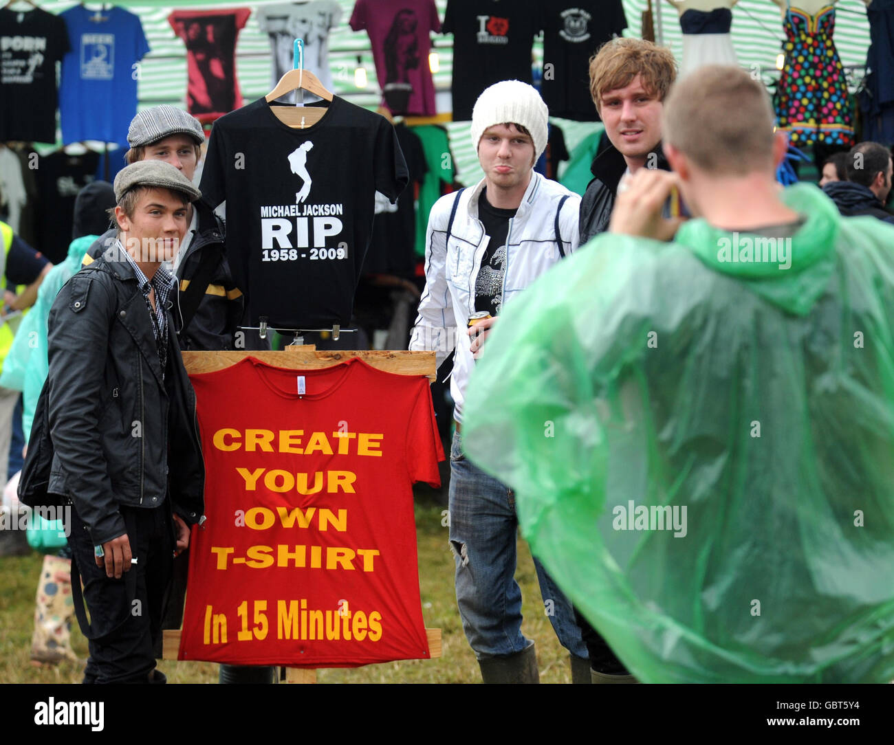 Festival goers pose for pictures beside a Michael Jackson tribute t-shirt during the 2009 Glastonbury Festival in Pilton, Somerset. Stock Photo