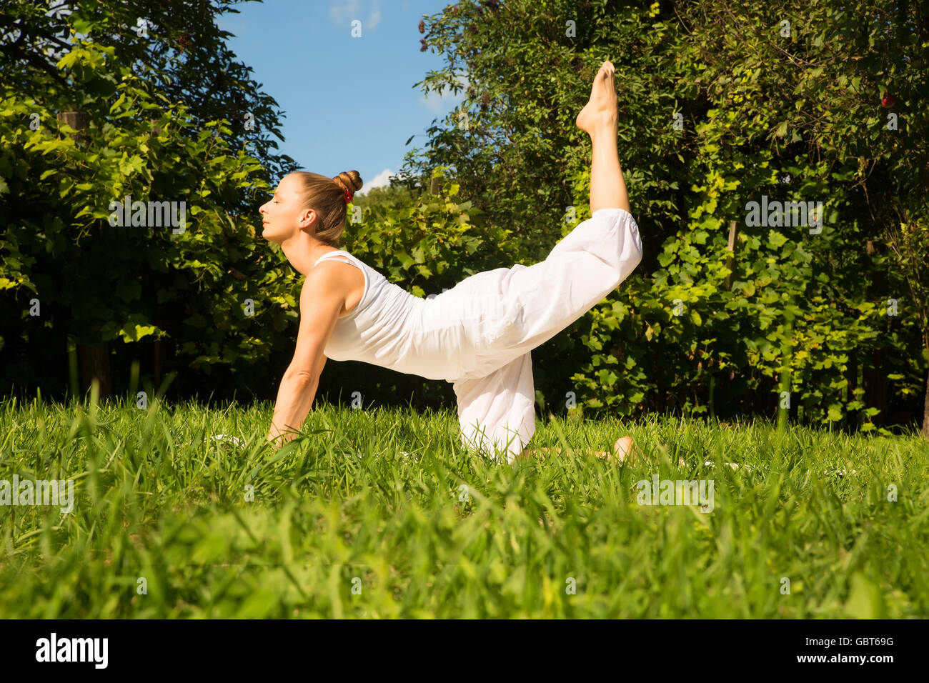 An Indian girl child practicing yoga in smiling face on yoga mat outdoors  Stock Photo - Alamy