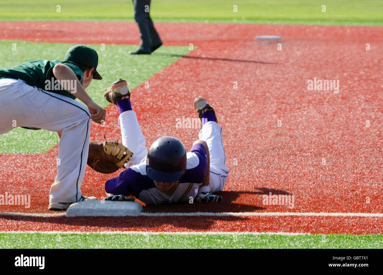 Baseball player tries to avoid pickoff Stock Photo