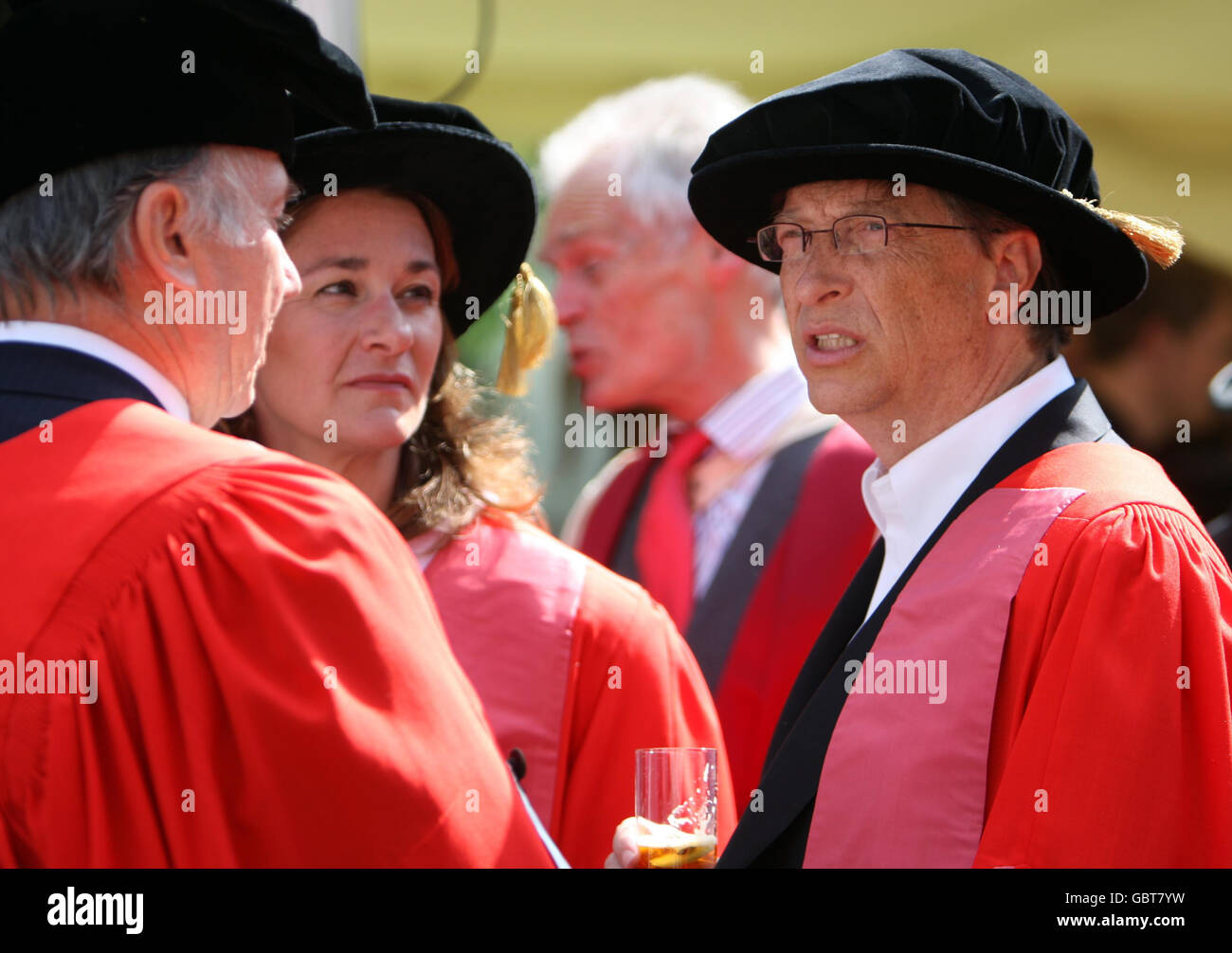Founder of The Microsoft Corporation Bill Gates (right) with his wife Melinda Gates at the Senate House at Cambridge University, after being made an honorary Doctor of Law during a ceremony at the University. Gates broke with tradition when he collected his degree in an open-necked shirt. Stock Photo