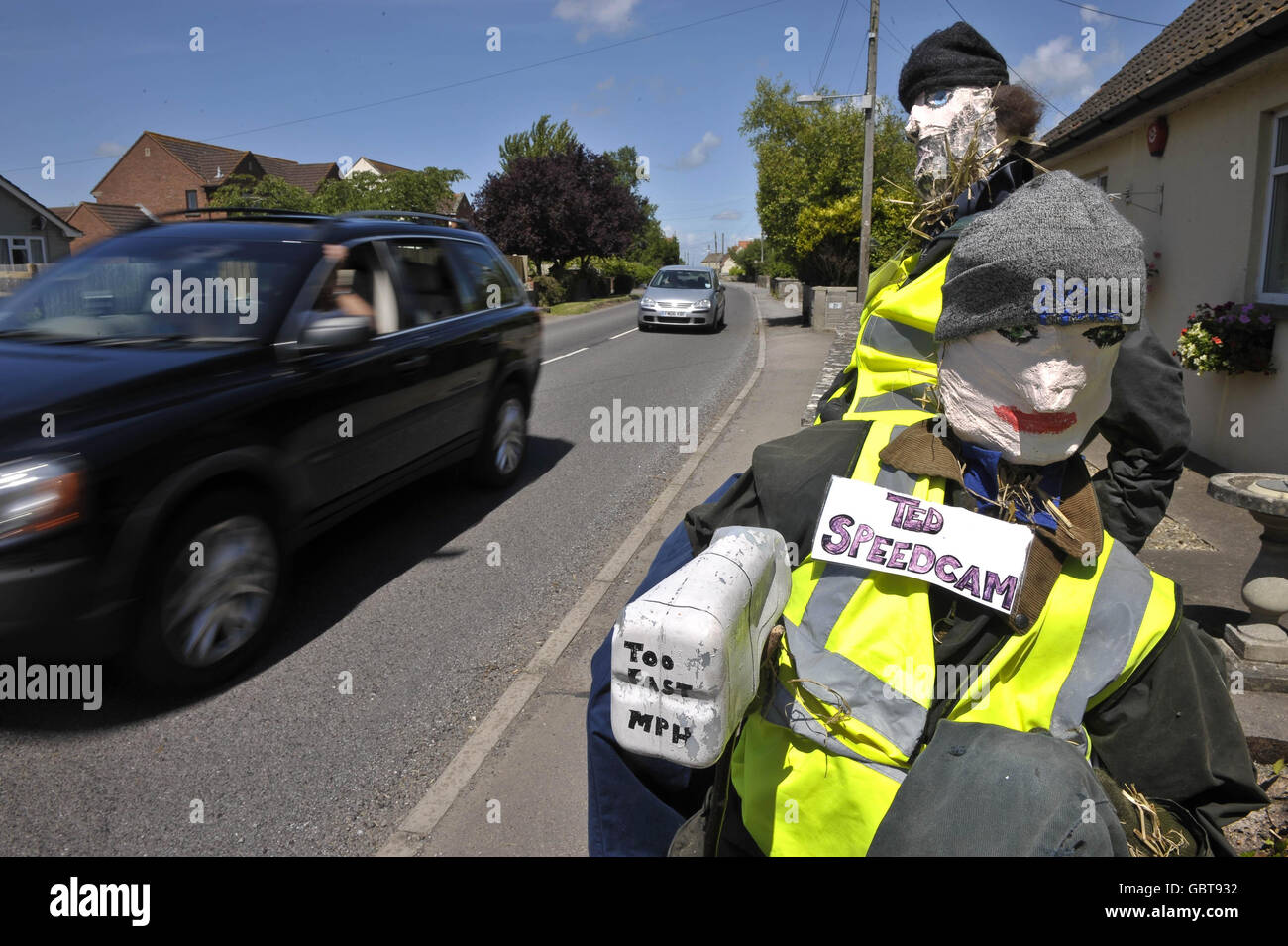Speed camera scarecrows. Ted and Barry the speed camera scarecrows in Glastonbury Road in Meare, Somerset. Stock Photo