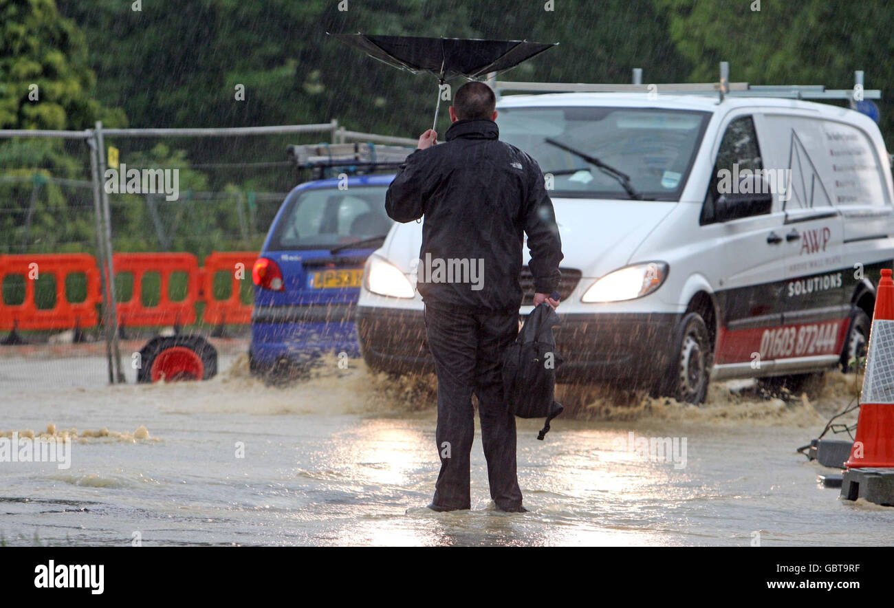 Warm weather. A van makes its way through the centre of Watton, Norfolk, as thunderstorms cause flash flooding in the area. Stock Photo
