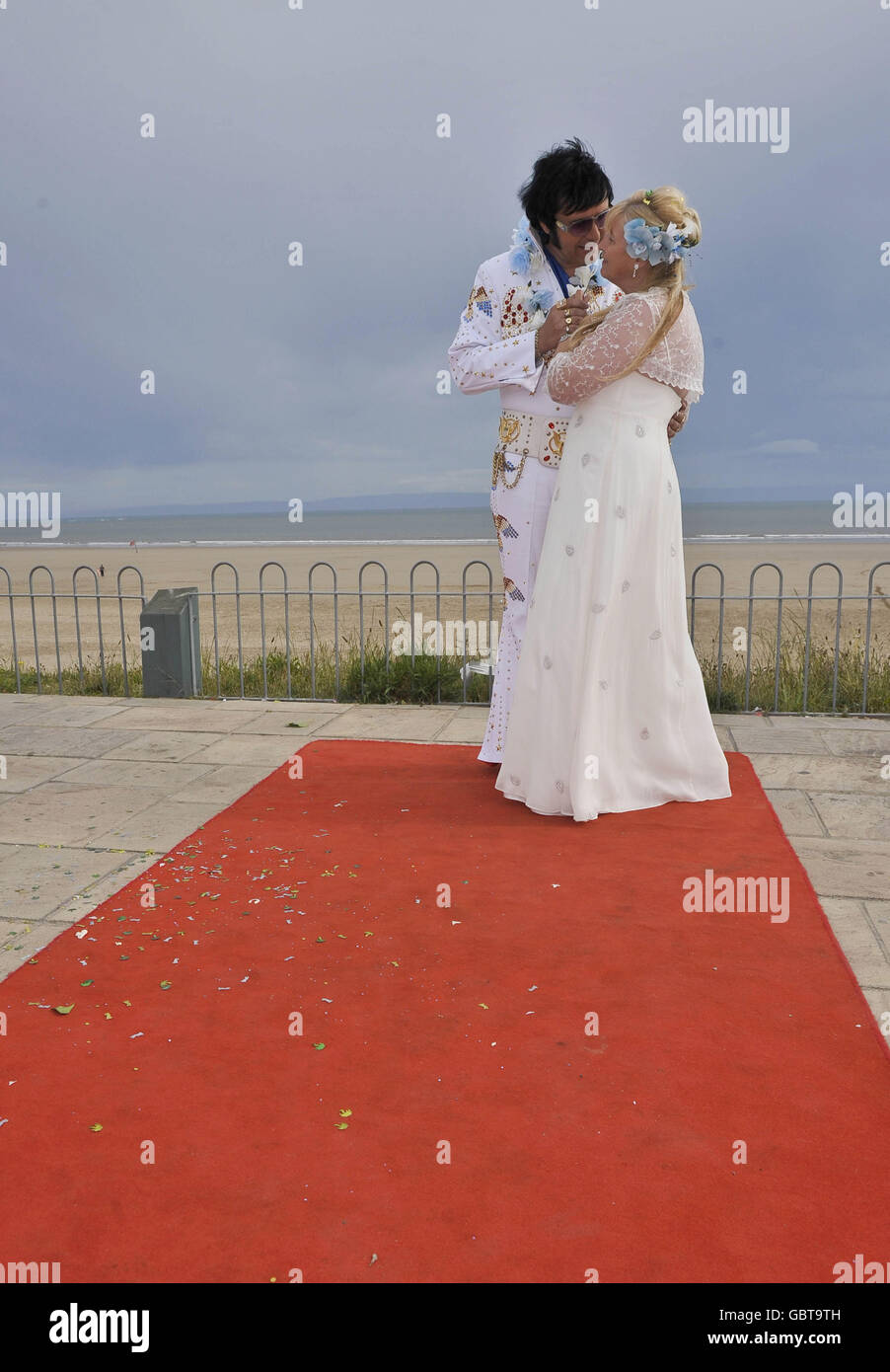 Steve Caprice, a leading professional Elvis tribute artist, and a fully ordained Minister, with his wife Barbara after their civil ceremony wedding in Porthcawl, Wales. The ceremony was a faithful recreation of the wedding scene from Elvis' Blue Hawaii film. Stock Photo