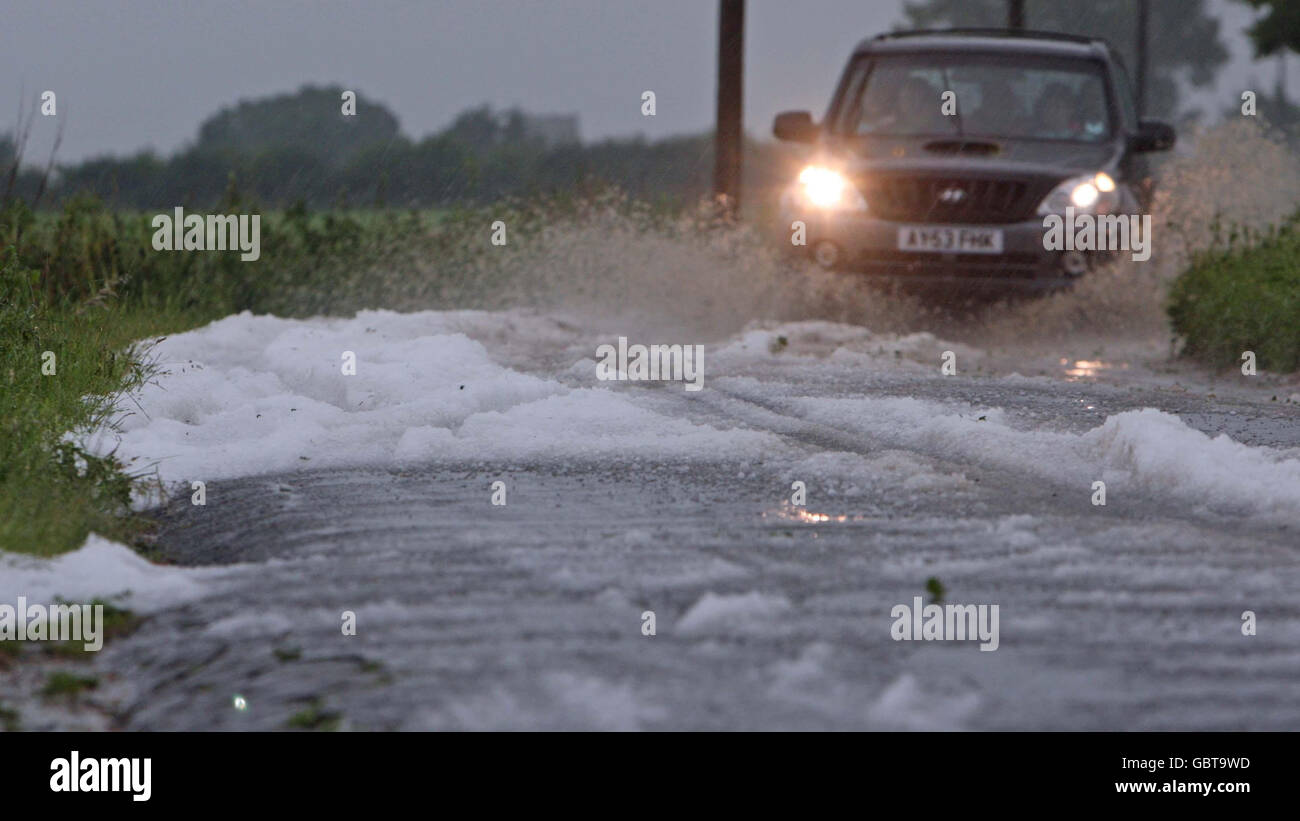 Hail stones on a road at Watton, Norfolk, as thunderstorms cause flash flooding in the area. Stock Photo
