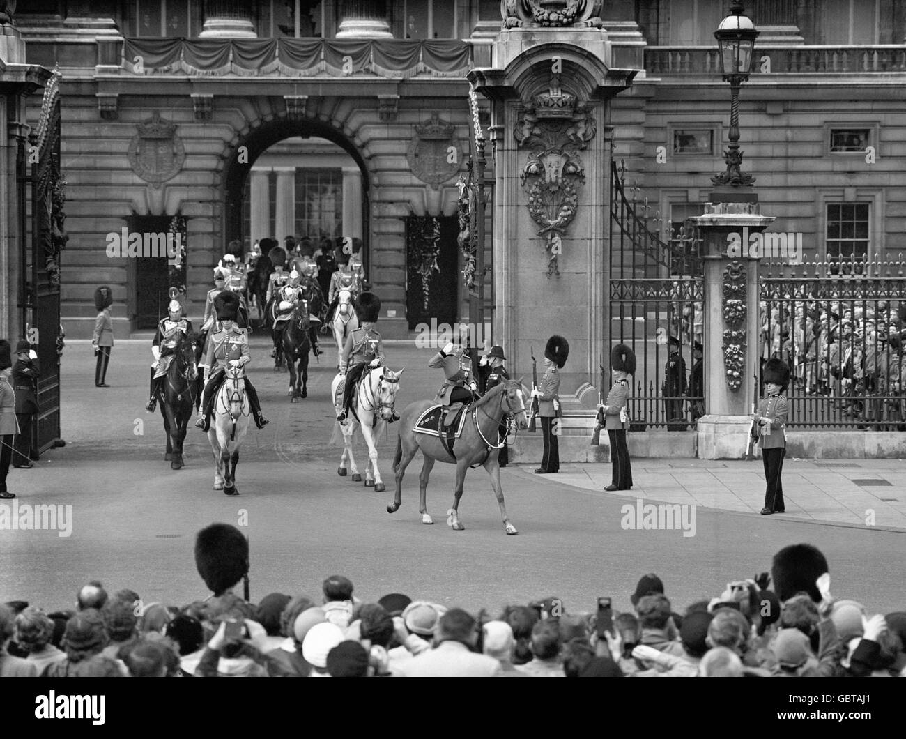 The Queen's official birthday was celebrated today (Thursday) with the traditional ceremony of 'Trooping the Colour' , this year that of the Coldstream Guards, on Horse Guards Parade. The Queen saluting as, watched by a crowd, she rides out of the gateway of Buckingham Palace on her way to the Trooping. Stock Photo