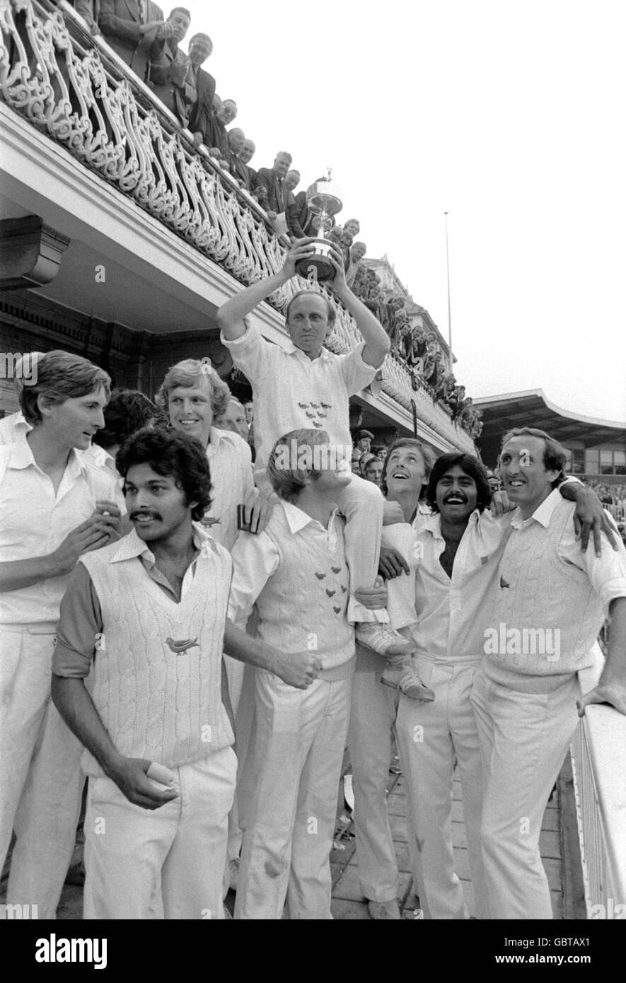 Sussex captain Arnold Long holds the Gillette Cup aloft as he is chaired by his jubilant teammates after their victory Stock Photo