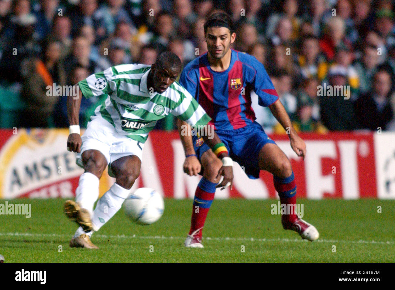 Soccer - UEFA Champions League - Group F - Celtic v Barcelona. Celtic's Henri Camara (l) and Barcelona's Rafael Marquez (r) battle for the ball Stock Photo