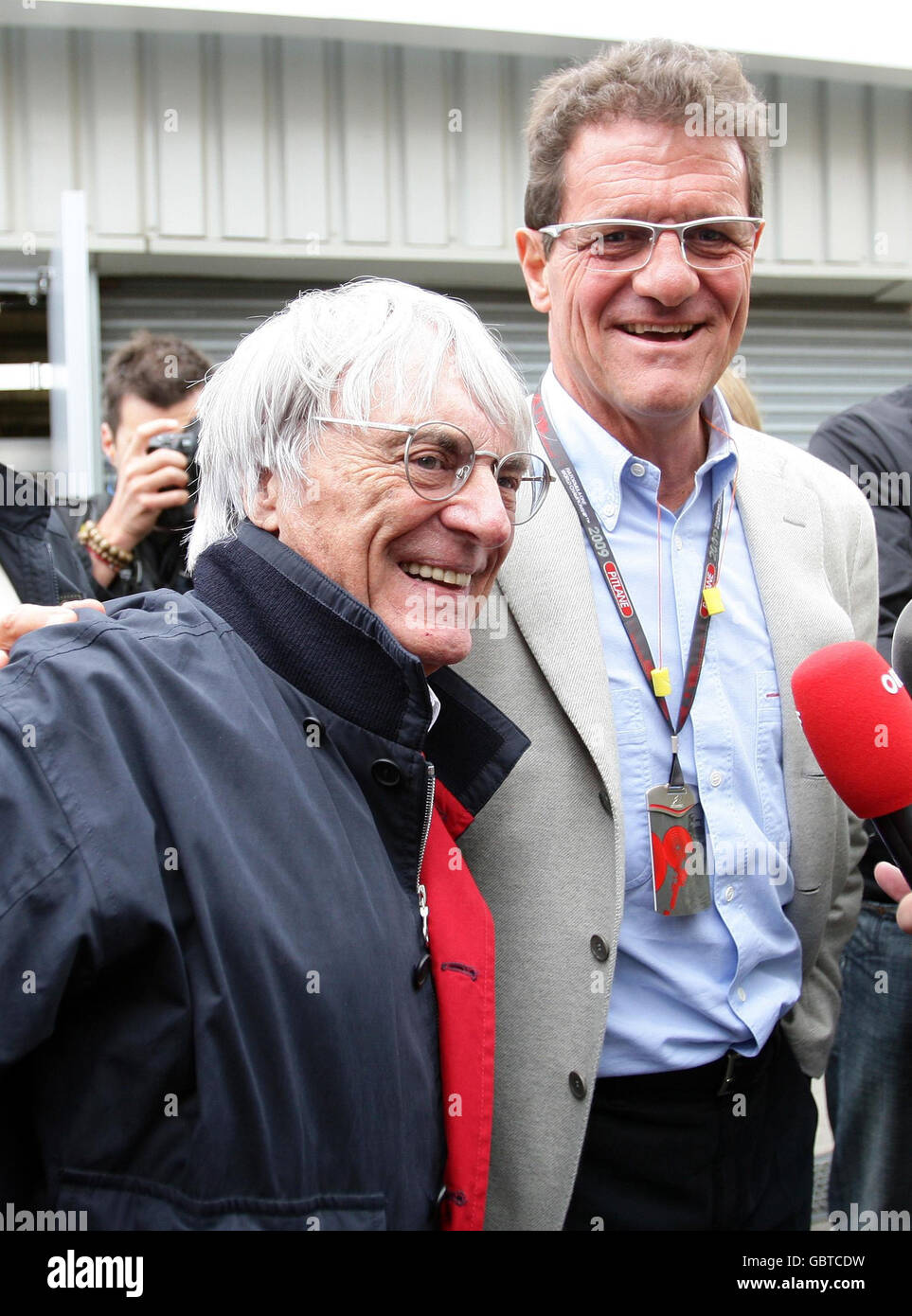 England manager Fabio Capello with President and CEO of Formula One Bernie Ecclestone (right) in the paddock during the practice session at Silverstone, Northamptonshire. Stock Photo