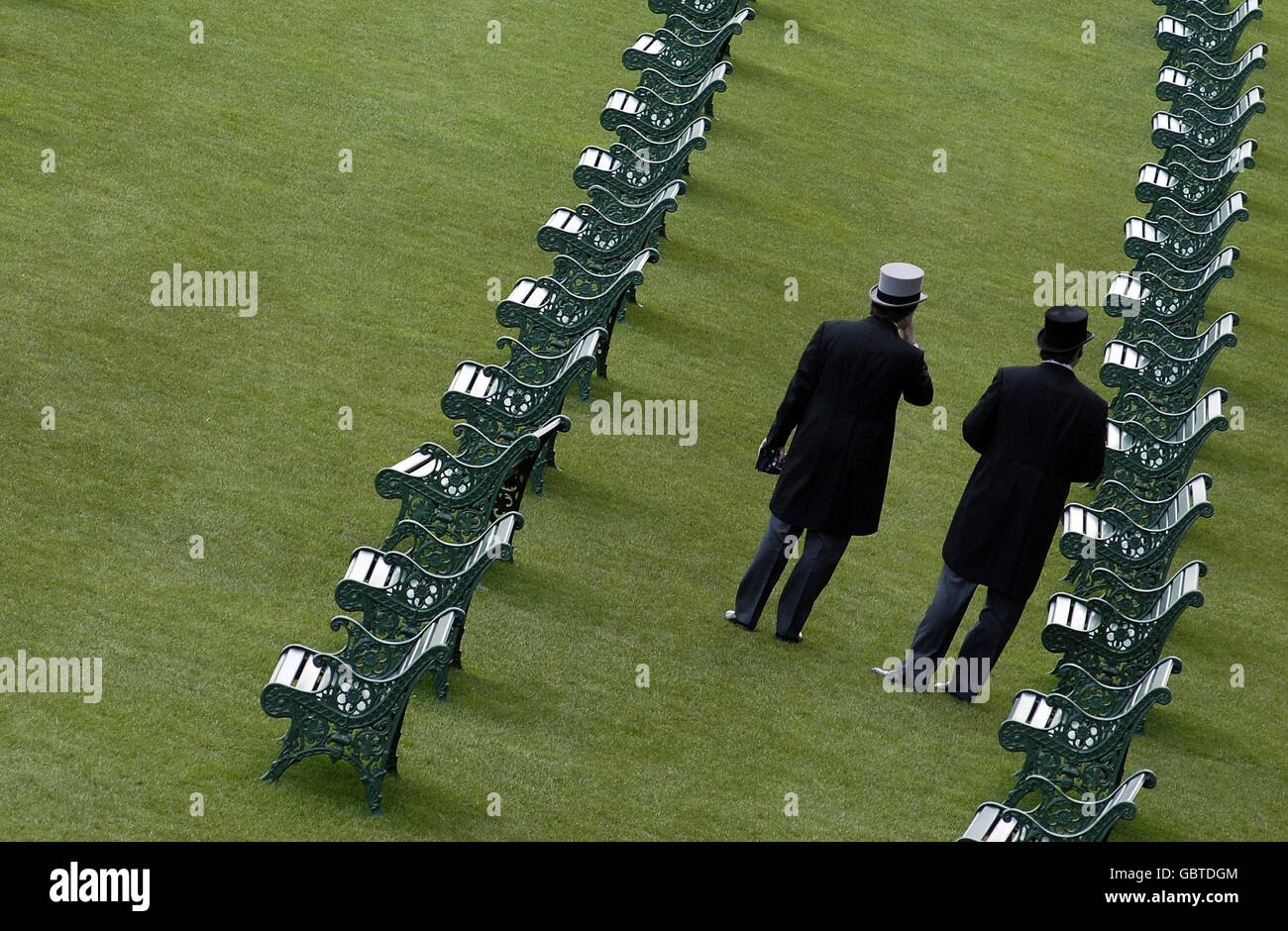 Two gentlemen stand on the lawns during day four of The Royal Ascot at Ascot Racecourse, Berkshire. Stock Photo