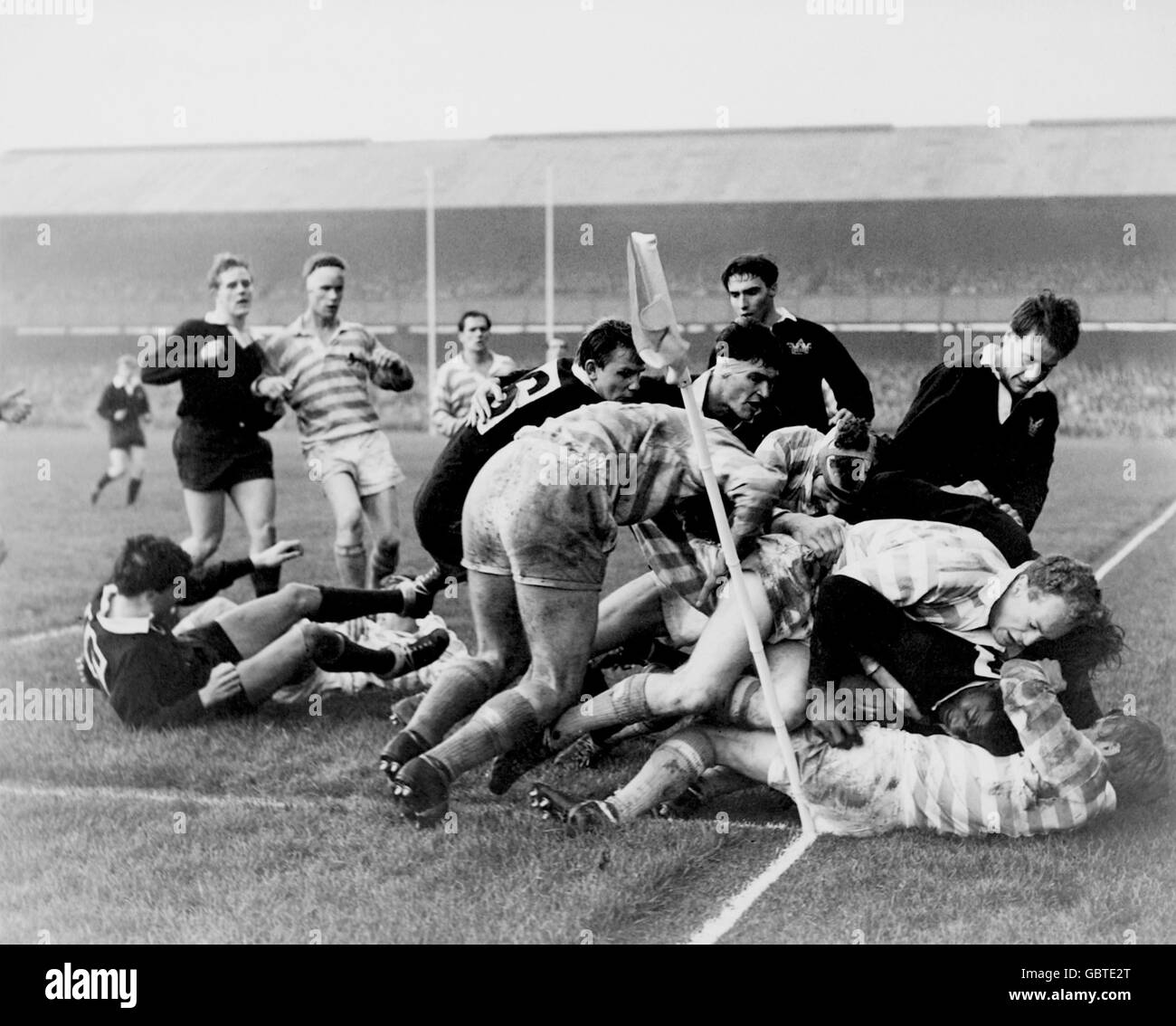 Oxford University's John Coker (dark shirt, on floor, r), the first black African to win a blue, is bundled into touch just short of the line Stock Photo
