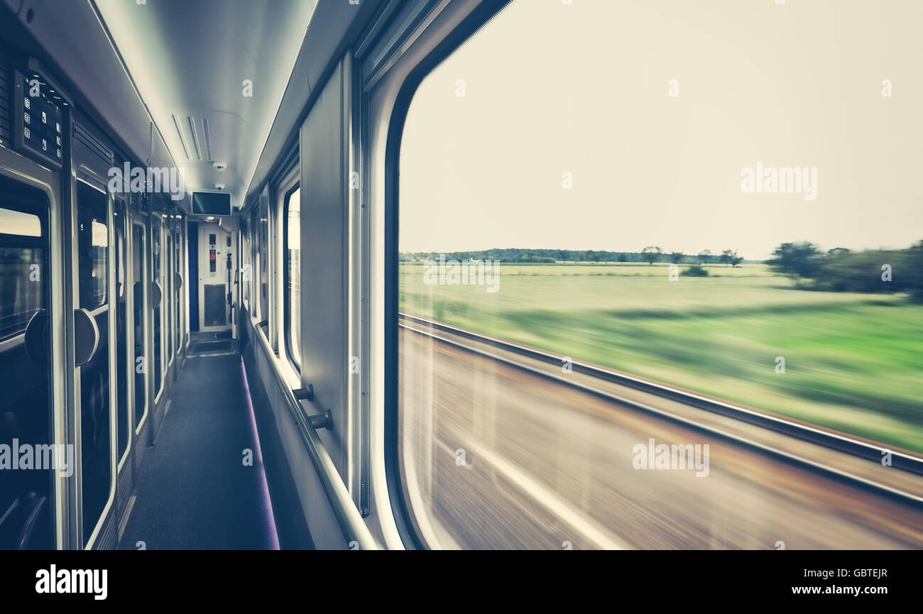 Retro toned train window with motion blurred view. Stock Photo