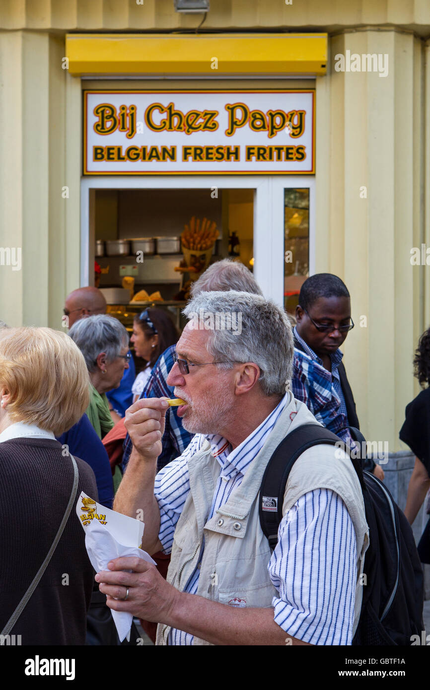 man eats eating frites french fries chips belgium Stock Photo