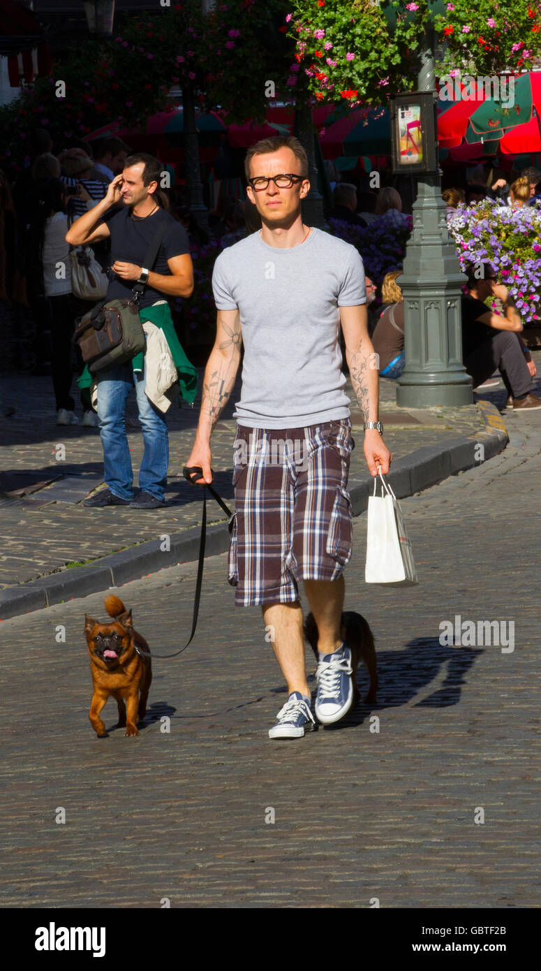 gay man walk walking pet dog public street summer Stock Photo - Alamy