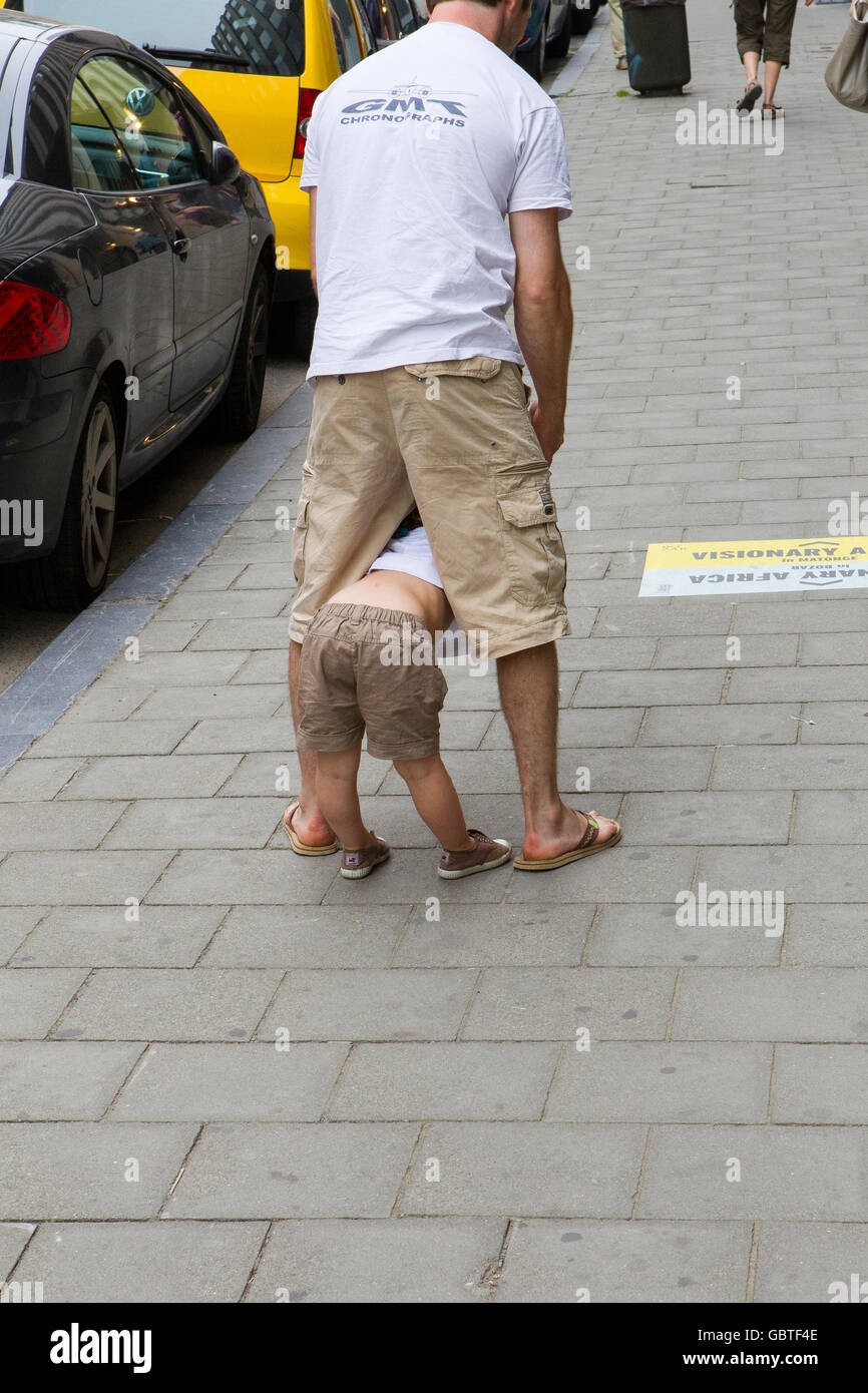 father dad son kid boy play playing game street Stock Photo - Alamy