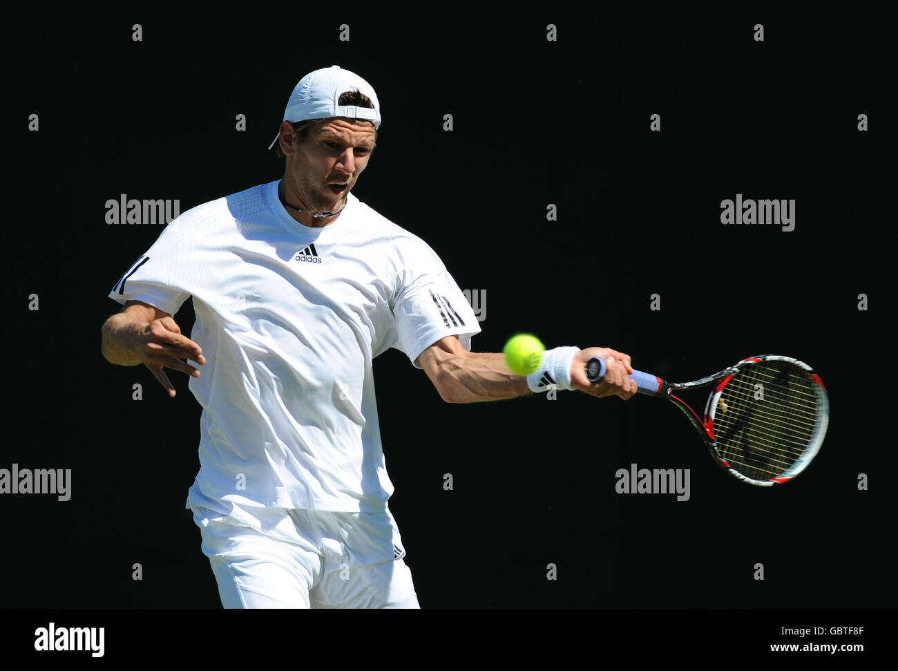 France's Paul-Henri Mathieu in action against Portugal's Frederico Gil during the 2009 Wimbledon Championships at the All England Lawn Tennis and Croquet Club, Wimbledon, London. Stock Photo