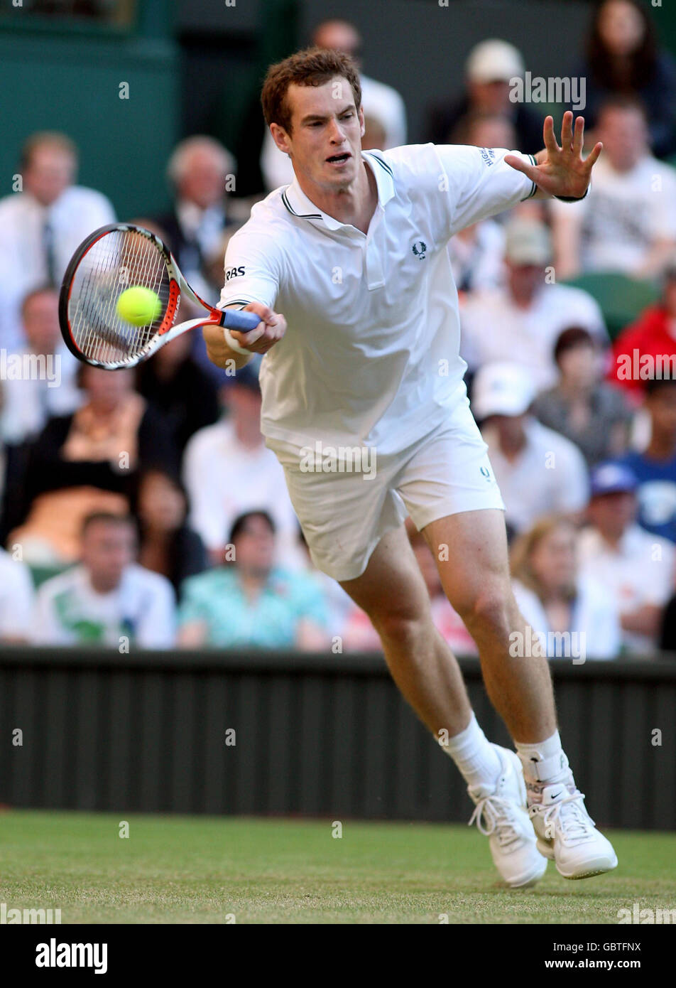 Great Britain's Andy Murray in action against USA's Robert Kendrick during the 2009 Wimbledon Championships at the All England Lawn Tennis and Croquet Club, Wimbledon, London. Stock Photo