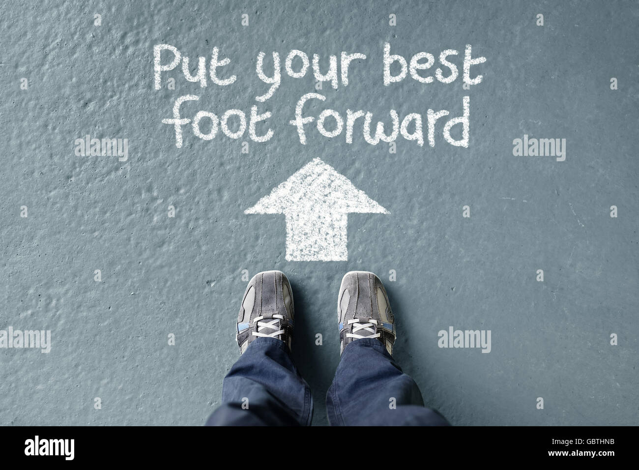 Put your best foot forward man standing with direction arrow to move forward Stock Photo