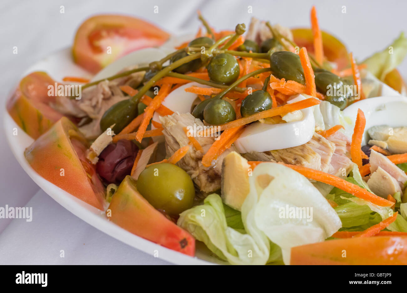 Traditional spanish, valencian salad with eggs, large capers, tuna and