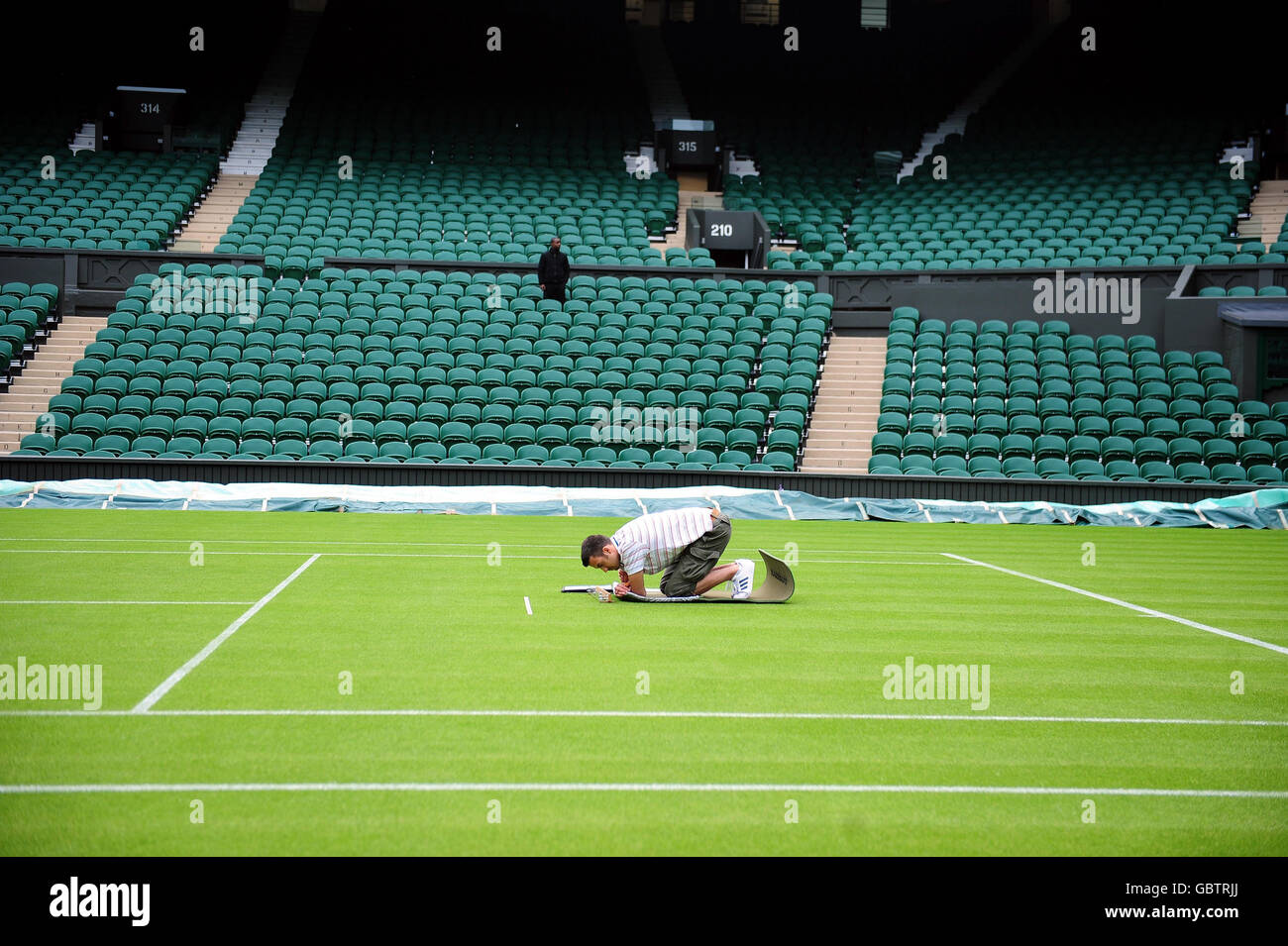 The grass is measured on Centre Court before the 2009 Wimbledon Championships at the All England Lawn Tennis and Croquet Club, Wimbledon, London. Stock Photo