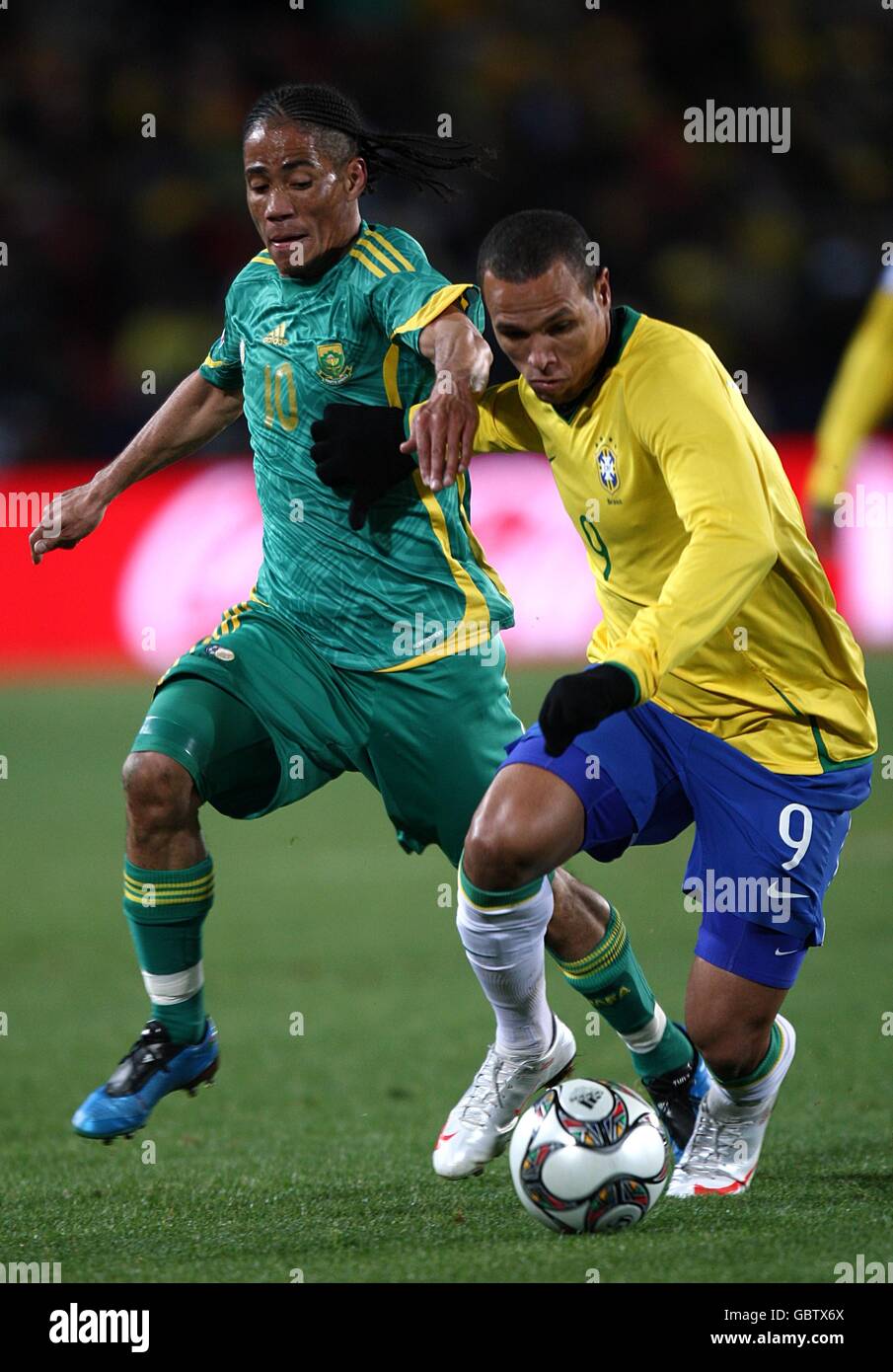 Soccer - 2009 FIFA Confederations Cup - Semi Finals - Brazil v South Africa - Ellis Park. Brazil's Luis Fabiano (right) and South Africa's Steven Pienaar (left) battle for the ball Stock Photo