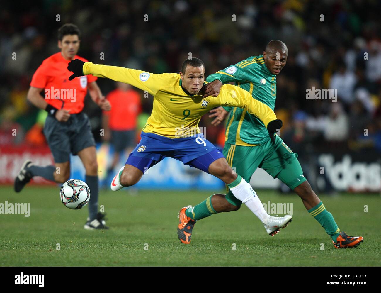 Soccer - 2009 FIFA Confederations Cup - Semi Finals - Brazil v South Africa - Ellis Park. Brazil's Luis Fabiano (left) and South Africa's Kagisho Evidence Dikgacoi (right) battle for the ball Stock Photo
