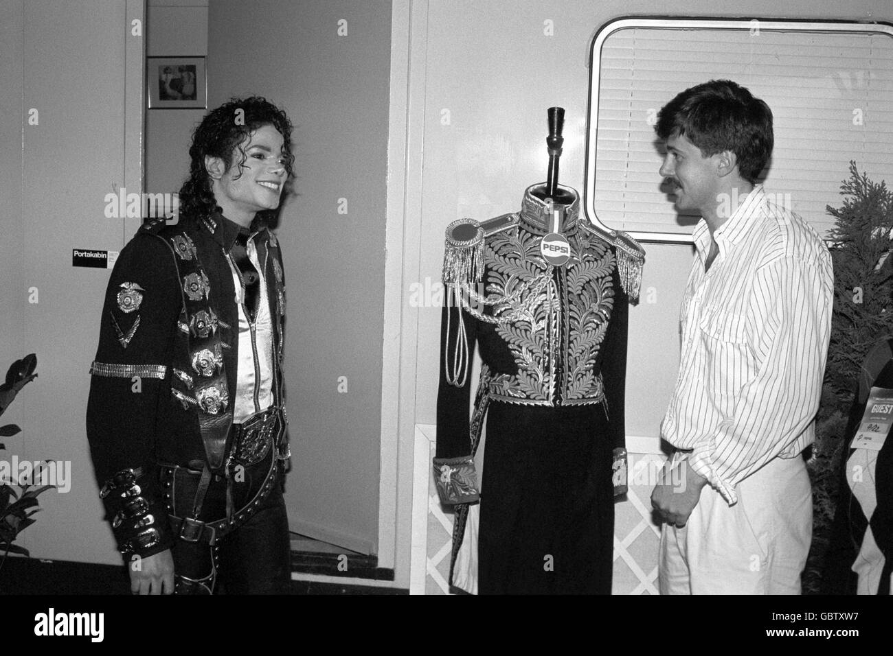 Pepsi-Cola's marketing manager Stacey Clark, presents military uniform fan Michael Jackson with a rare 19th century Full Dress British Diplomatic Tunic before the American pop star went on stage at Wembley. Stock Photo