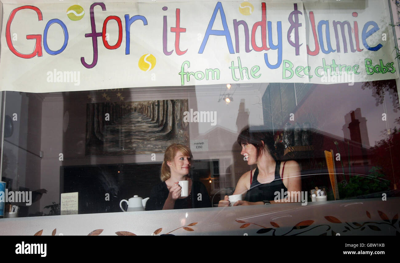 Emma Miller (left) and Vicki Smith through the window of the Beech Tree Cafe in the home town of Scottish tennis player Andy Murray, Dunblane. Murray aims to be the first Britain in 71 years to reach the men's singles final at the All-England Club. He plays Andy Roddick in the semi-final. Stock Photo