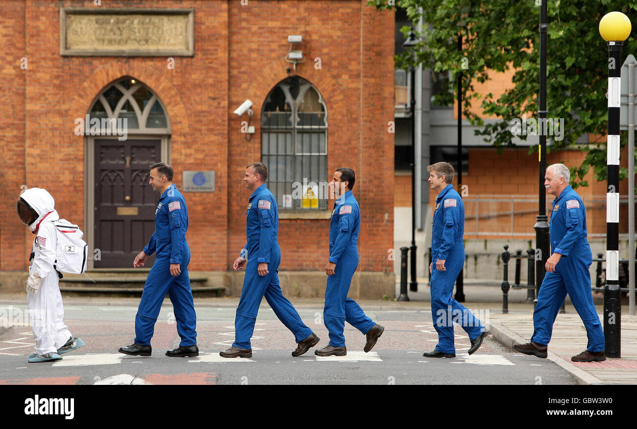 13-year-old Josh Ellis leads astronauts from the space shuttle Discovery who have just returned from the International Space Station, into the Museum of Science and Industry in Manchester.The US crew embark on an educational mission throughout Britain today. Stock Photo