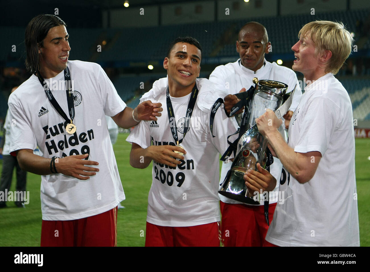 Germany's Sami Khedria (left), Anis Ben-Hatira (centre), Jerome Boateng (2nd left) and Andreas Beck celebrate with the trophy after winning the UEFA European U-21 Championship 2009 Final. Stock Photo