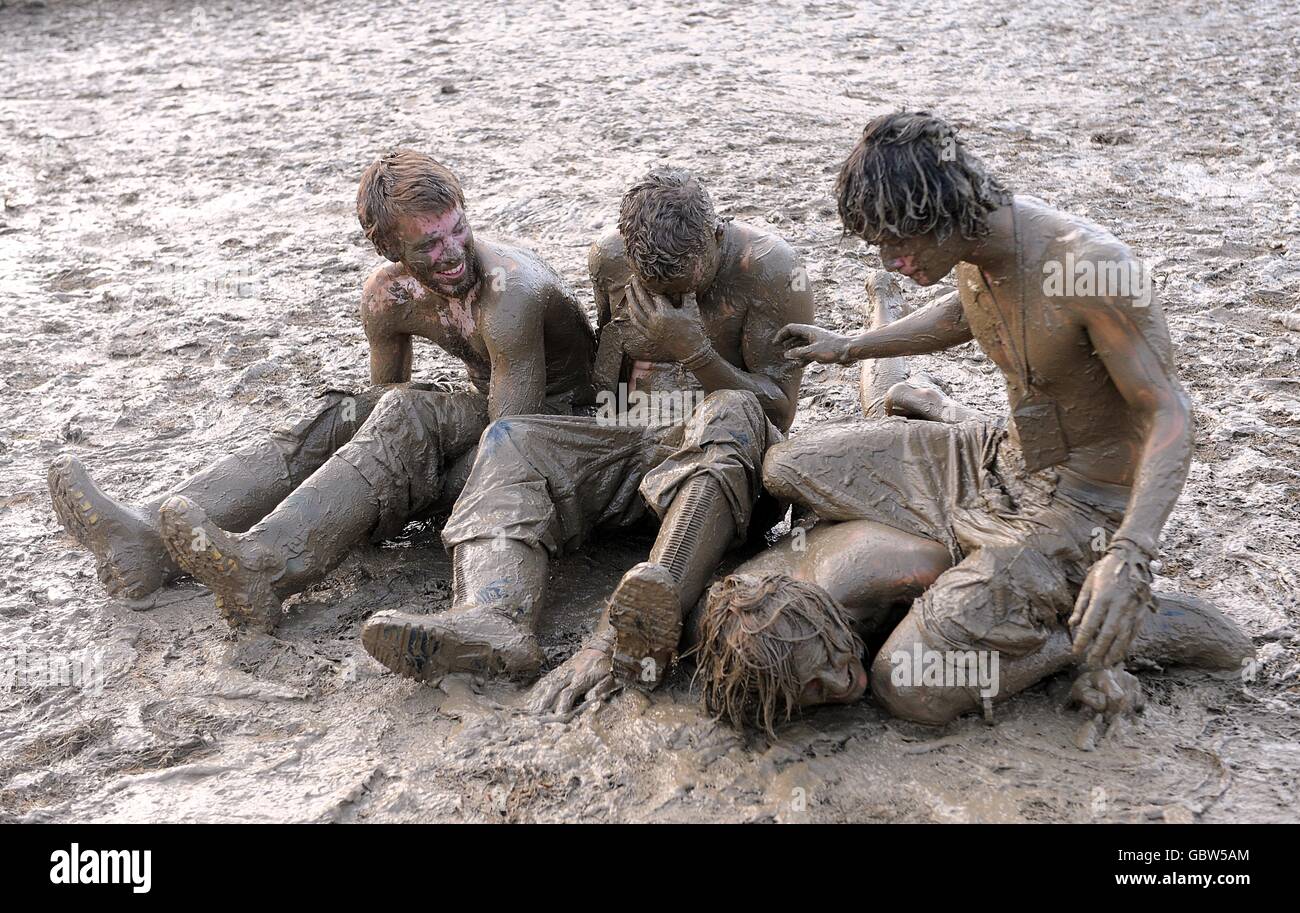 A festival goers covered in mud after wrestling match at the 2009 Glastonbury Festival at Worthy Farm in Pilton, Somerset. Stock Photo