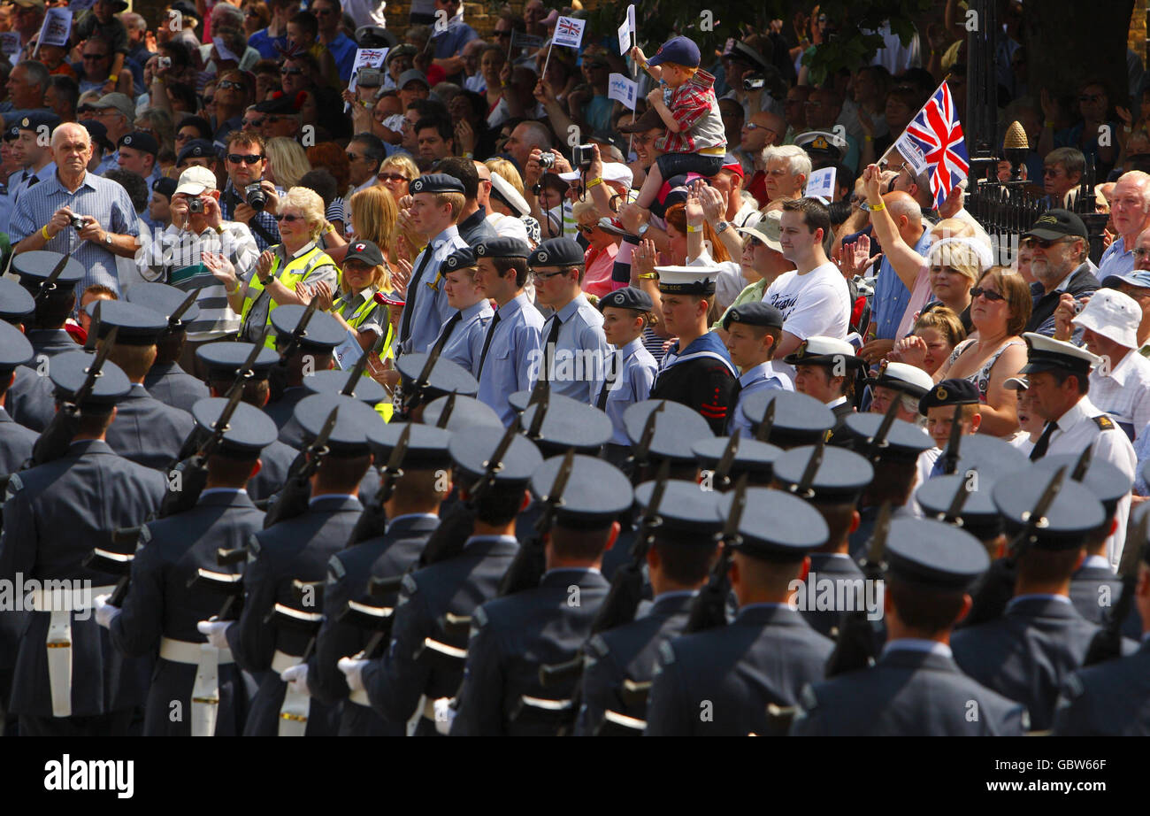 Crowds applaud as service men and woman from the three forces parade into the Historic Dockyard in Chatham, Kent to mark the first annual Armed Forces Day. Stock Photo