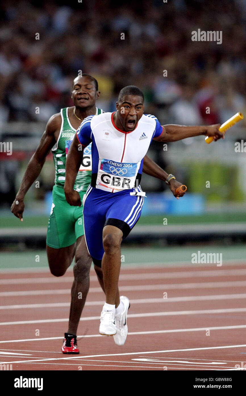 Athletics - Athens Olympic Games 2004 - Men's 4 x 100m Relay - Final. Great Britain's Mark Lewis-Francis celebrates as he brings the 4x100m relay team home to the gold medal Stock Photo