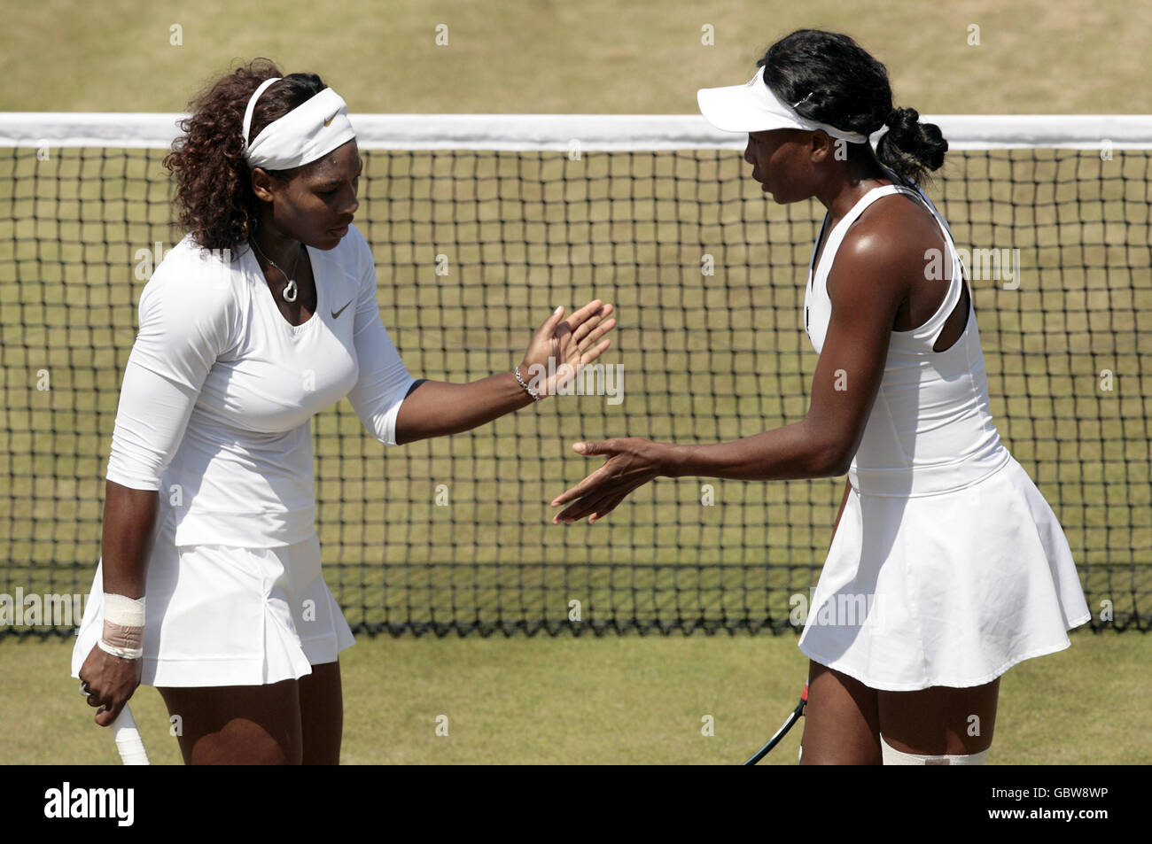 USA's Serena Williams (left) and Venus Wiliams (right) during their match against Germany's Anna-Lena Groenefeld and USA's Vania King Stock Photo