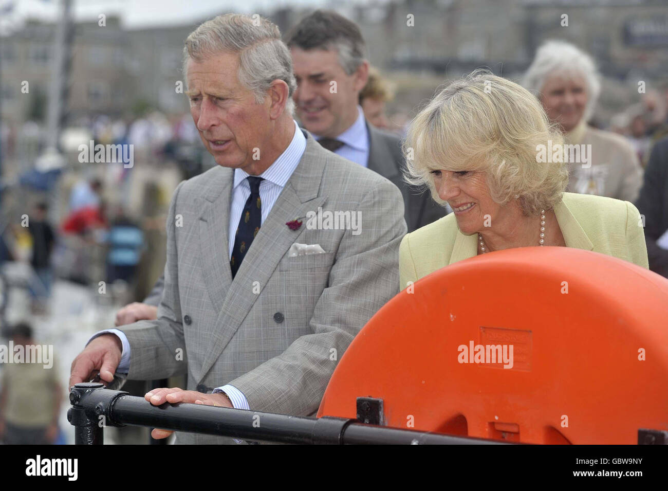 The Prince of Wales and The Duchess of Cornwall look out over the harbour at Porthmellon, St Mary's, Isles of Scilly. Stock Photo