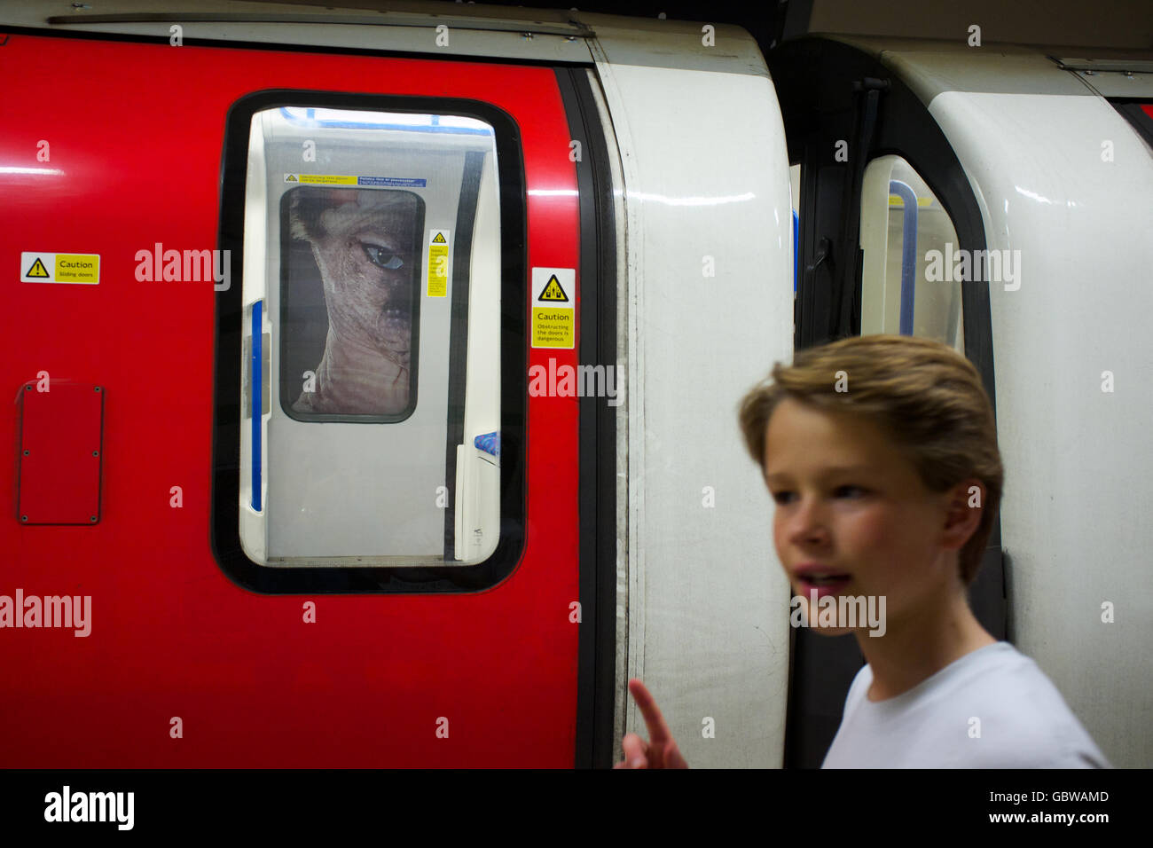 Spooky Creature Watching A Young Commuter On The London Underground Stock Photo Alamy