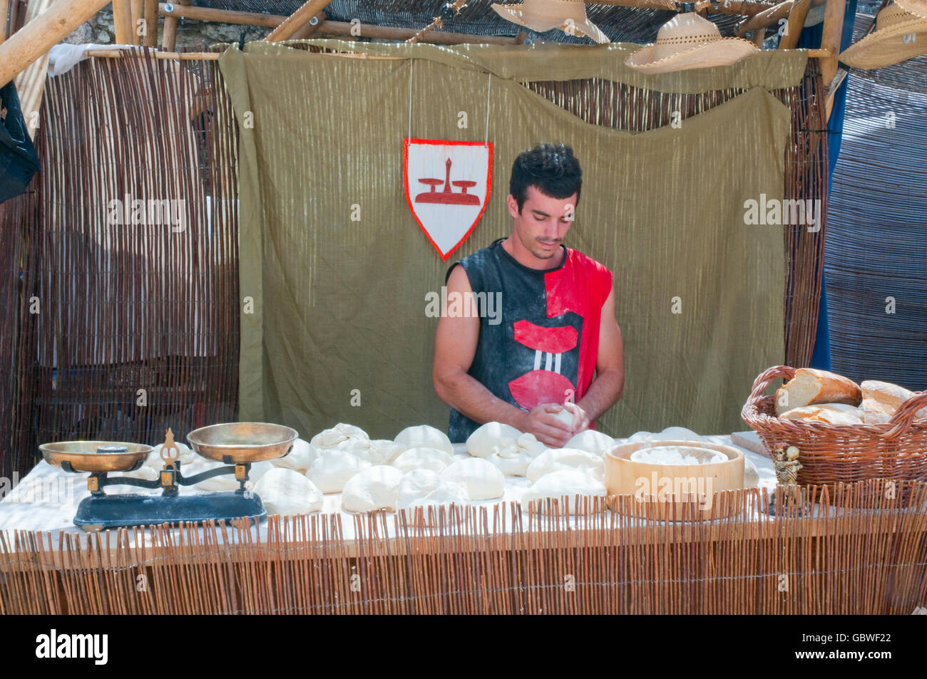 Baker kneading the dough, medieval flea market. Medieval Days, Sigüenza, Guadalajara province, Castilla La Mancha, Spain. Stock Photo