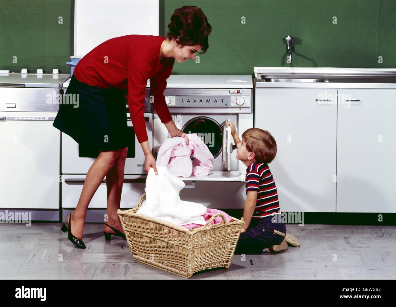household, washing, mother with son placing laundry in washing machine, 1960s, , Additional-Rights-Clearences-Not Available Stock Photo