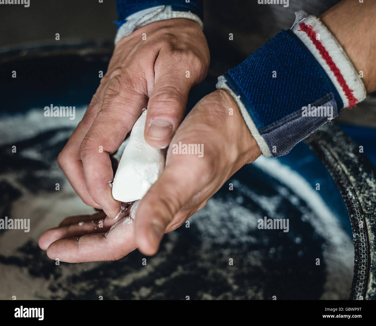 Man prepares for crossfit workout and chalk his hands before