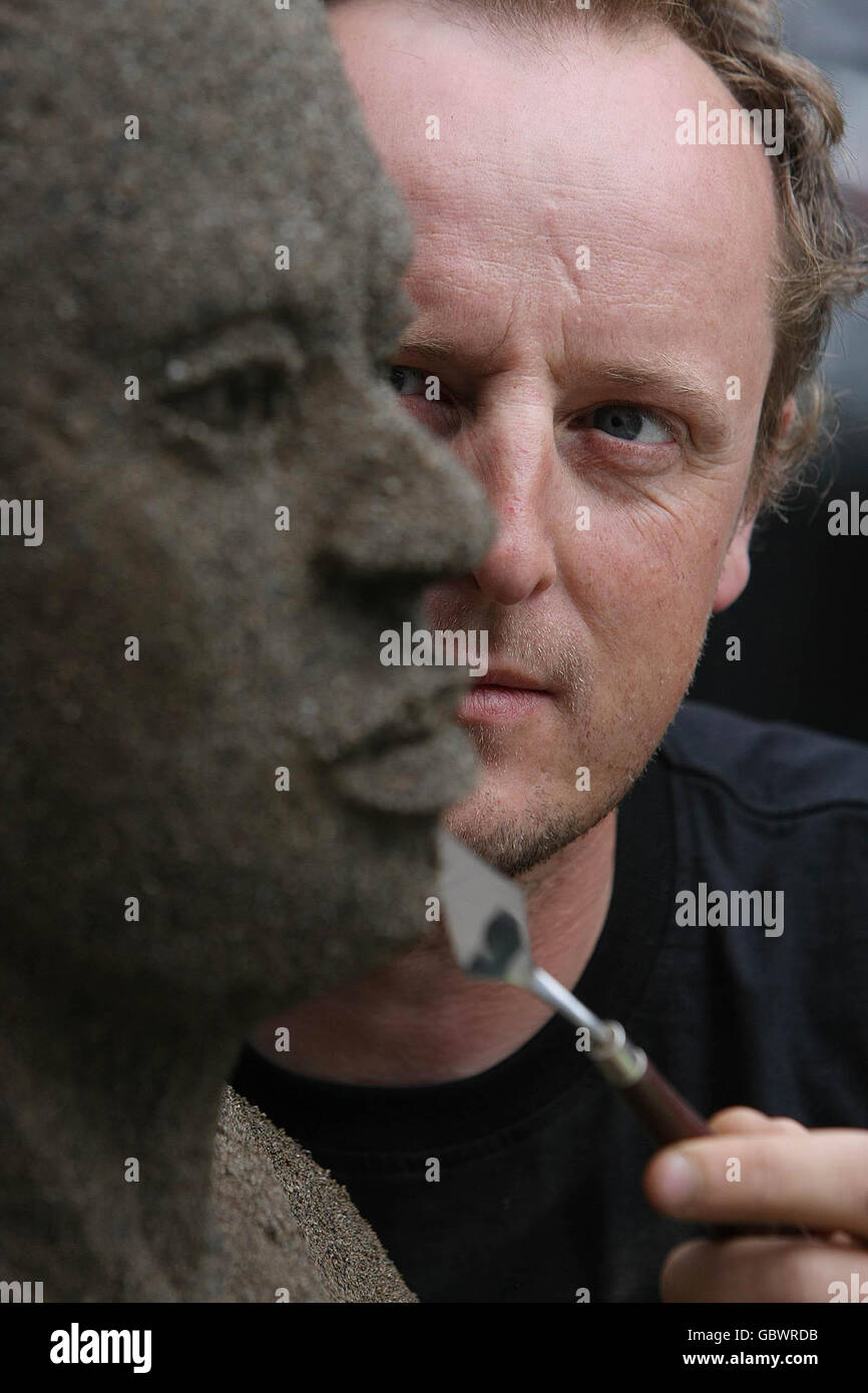 Artist Daniel Doyle puts the finishes touches to his life sized sand ...