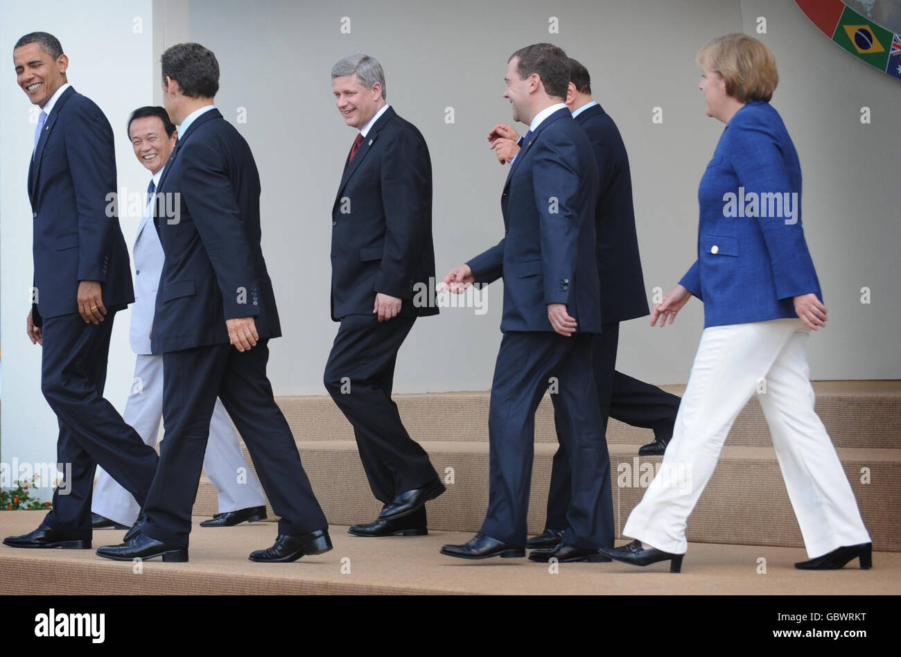 G8 leaders leave the stage after posing for their family photo (from left to right) President of the USA Barack Obama, Japanese Prime Minister Taro Aso, French President Nicolas Sarkozy, Canadian Prime Minister Stephen Harper, President of Russia Dmitry Medvedev, Prime Minister Silvio Berlusconi and Chancellor of Germany Angela Merkel at the G8 Summit in L'Aquila today. Stock Photo