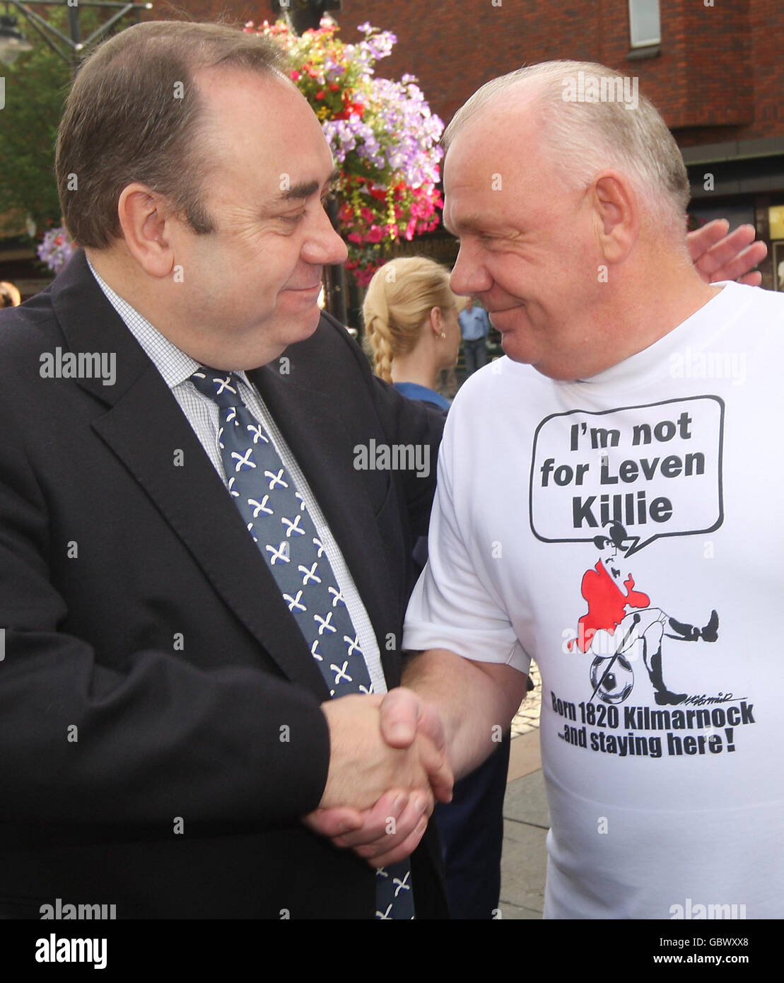 First Minister Alex Salmond (left) meets Billy Paterson, who has worked at the Johnnie Walker bottling plant in Kilmarnock for 44 years - making him the longest serving member of staff, during a visit to Kilmarnock to sign a petition to save Diageo jobs. Stock Photo